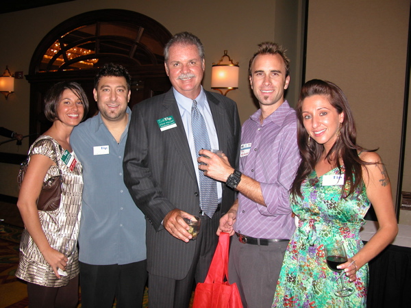 Nicole Geroni of Prestige Insurance, left, with an unidentified gentleman, Steve Pollart of Wells Fargo, Ryan McFarland of WestStart Mortgage and Julie Markey of Bliss Salon. 