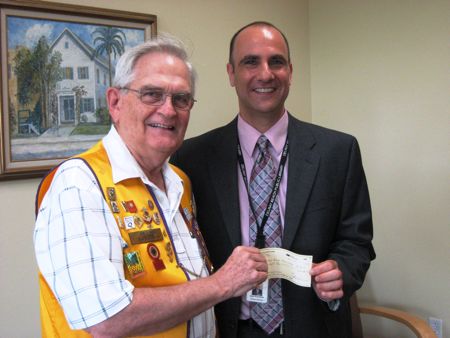 John S. Parke of the Lions Club, left, gives donation to Delray Library Director Alan Kornblau.