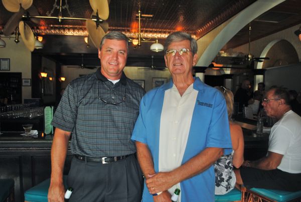 Kevin Lange of Kaplan University with Bill Fagin of B&T Asset Management. Fagin is wearing one of the men's group signature bowling shirts.