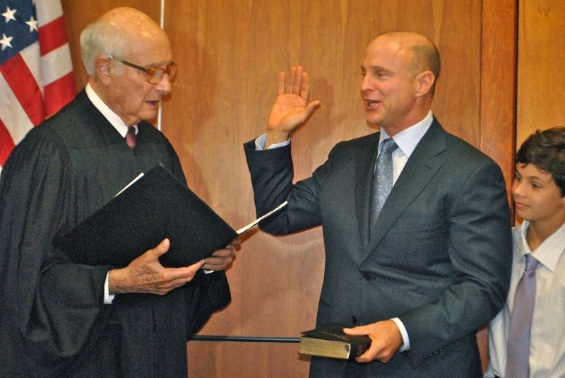 Senior Circuit Court Judge William E. Gladstone administers the oath of office to Delray Beach Mayor Cary Glickstein Thursday evening, as Glickstein's looks on. 