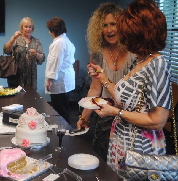 Let them eat cake! Those attending the grand opening for Adina's Cakery sample some of Adina Serell's work. 