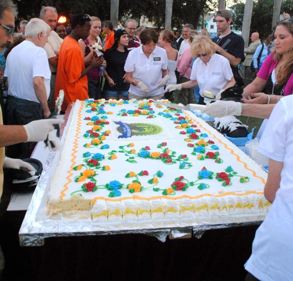 Marjorie Ferrer of the Downtown Development Authority helps cut and serve birthday cake at Old School Square.