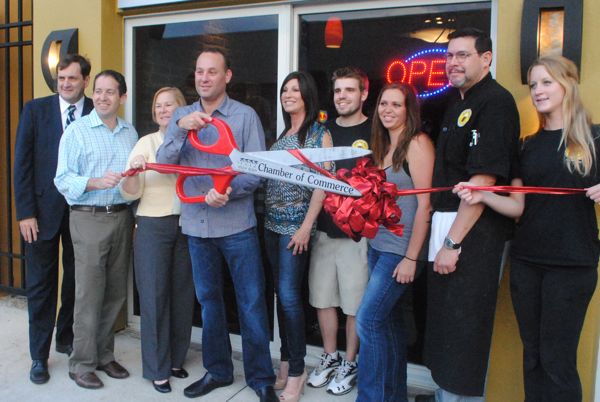 The Off The Avenue grand opening: from left, Delray Beach Chamber of Commerce President Mike Malone, City Commissioner Adam Frankel, Susan Taurello of Delray chamber board, co-owner Adam Knoblock, co-owner Jolene McClure and employees Trevor Kelly, Megan Wiseley, Carolos Ubilla and Anna Stettler.