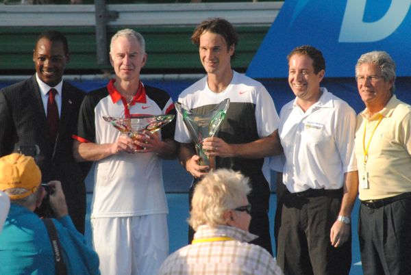 John McEnroe and Carlos Moya, display their trophies with Delray Beach city commissioners Al Jacquet, left, and Adam Frankel, second from the right, and Delray Beach ITC Director Mark Baron. 