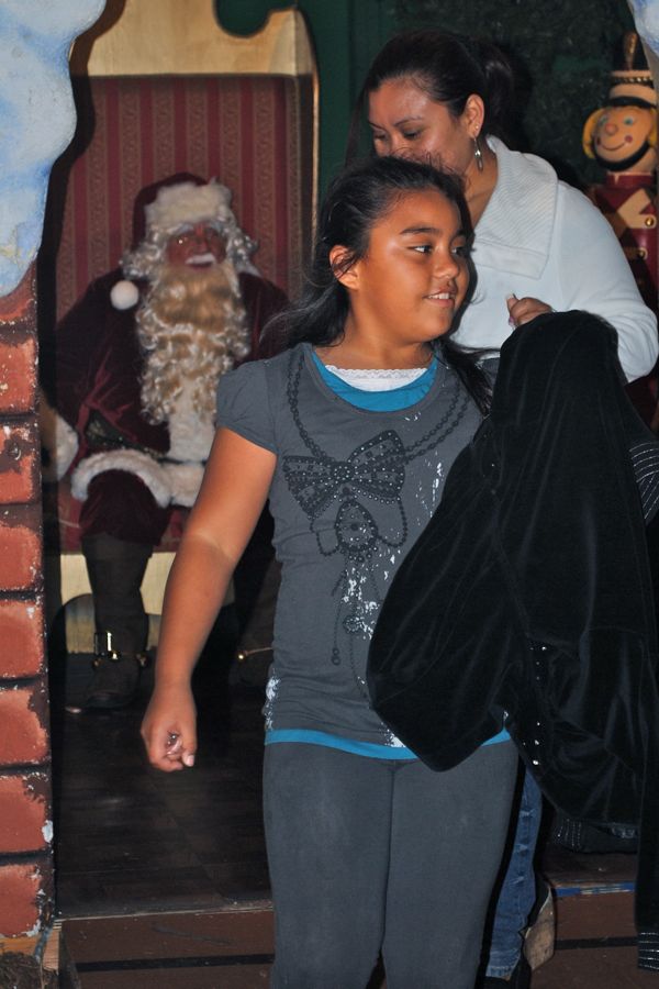 Presumably another one of Santa's satisfied customers to be. Santa set up shop on Old School Square.